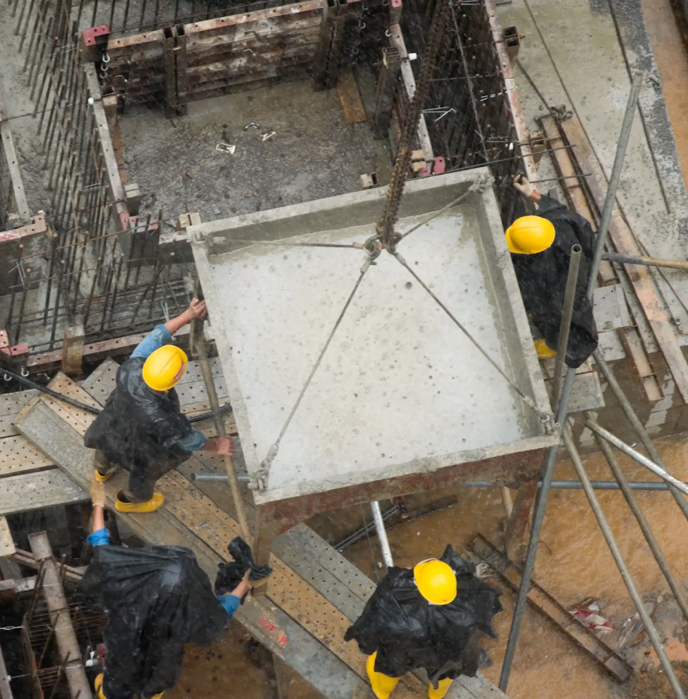 Construction workers pouring concrete into a foundation.